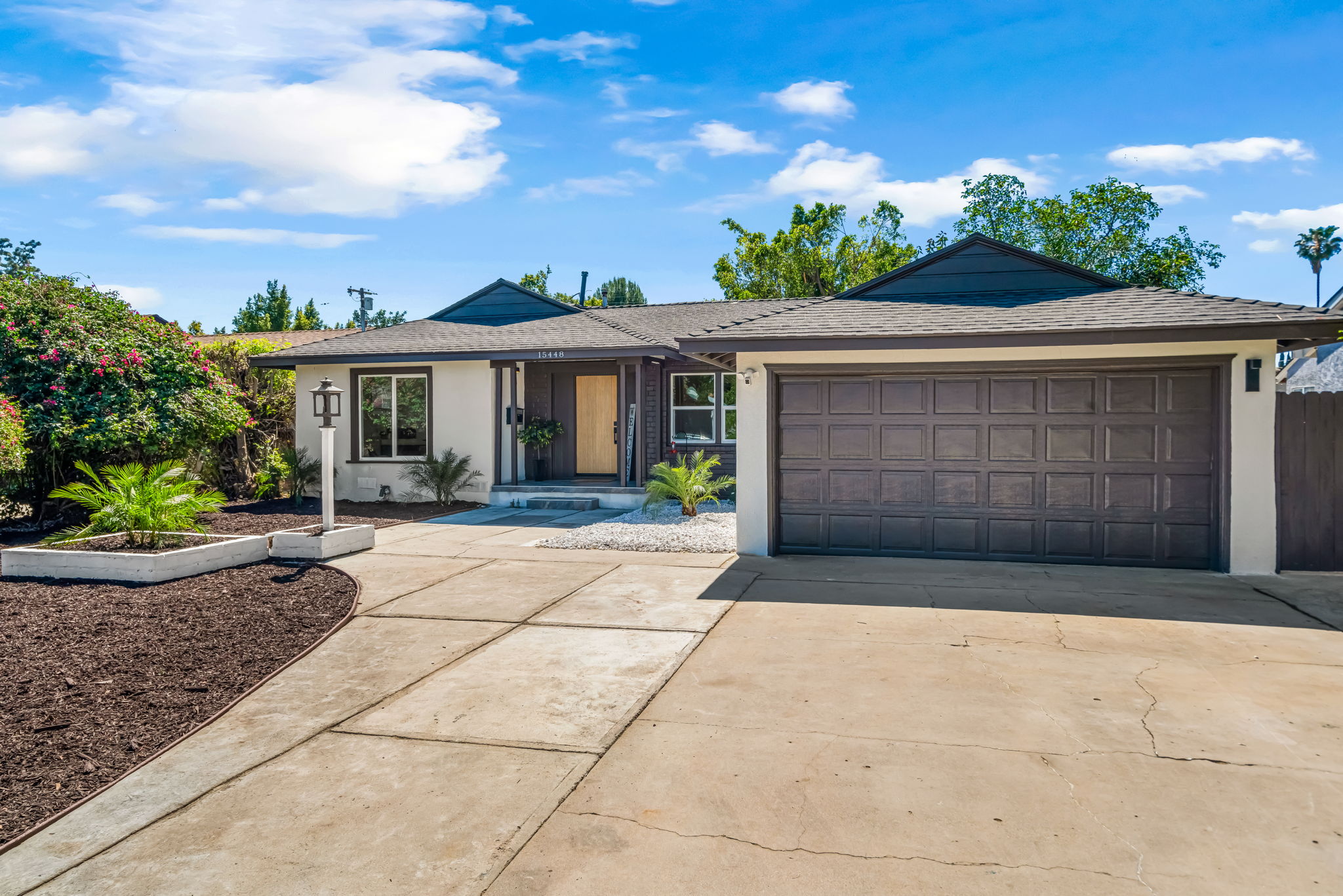Front exterior angle — curb appeal with sago palm and white rock