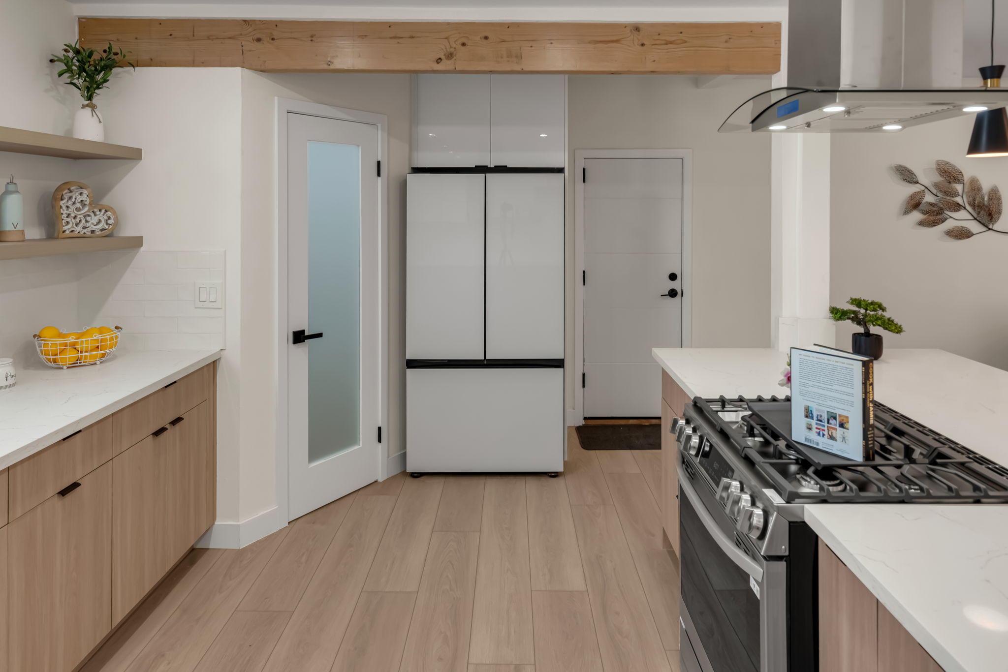 Kitchen — stainless range, modern fridge, exposed beam
