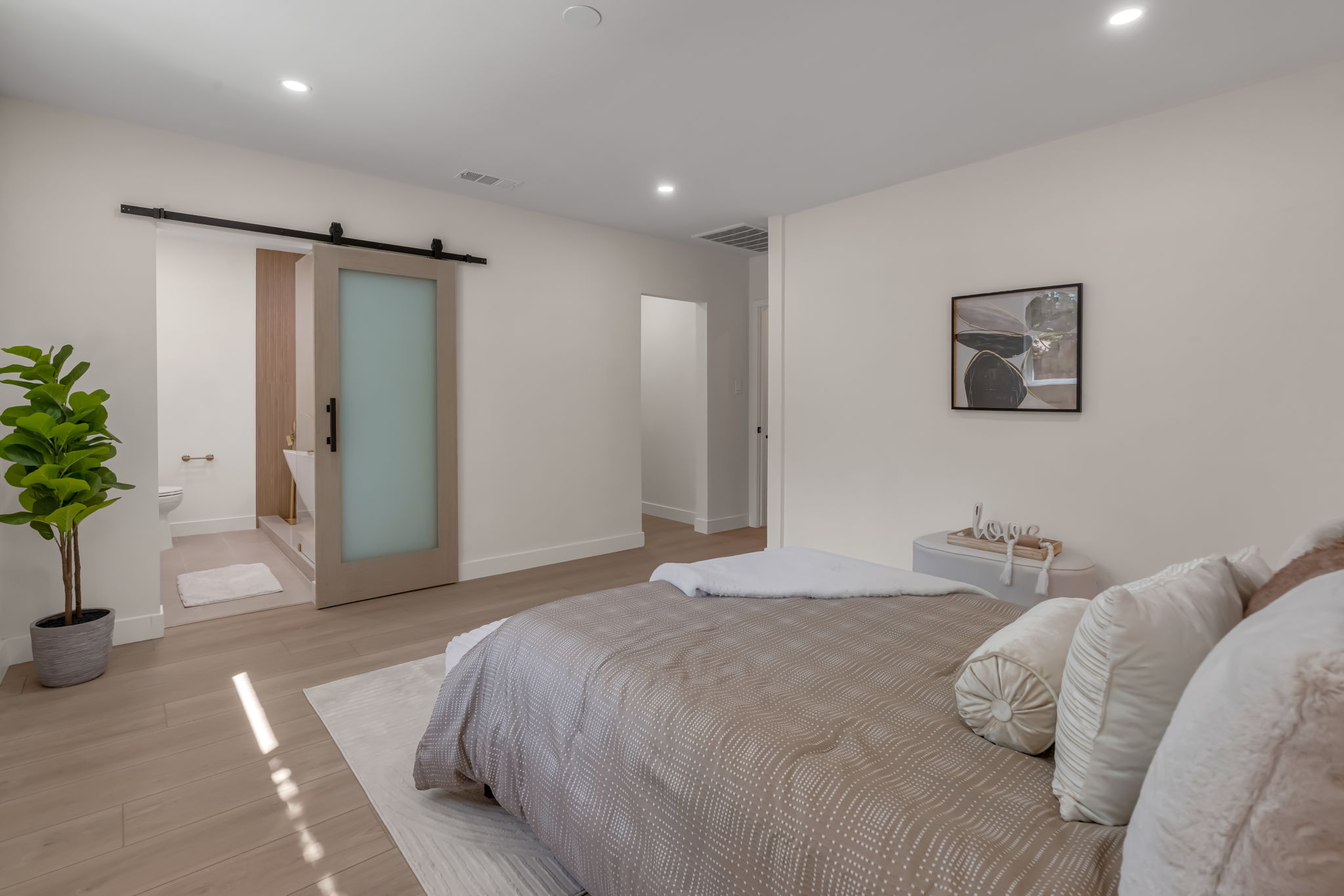 Primary bathroom vanity with gold fixtures