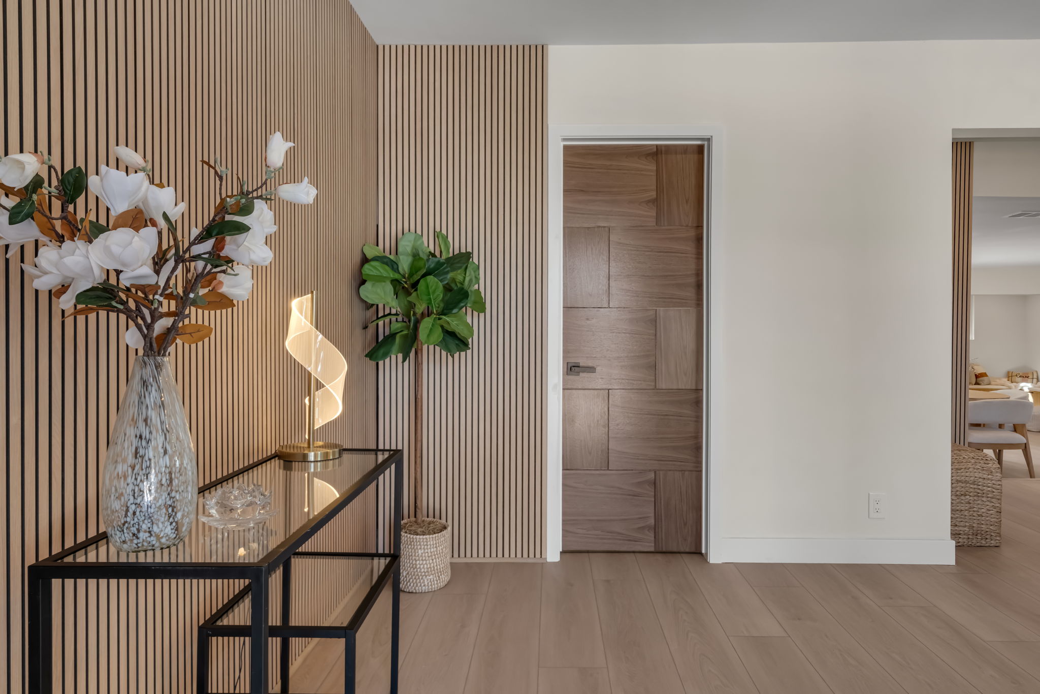 Slatted wood accent wall with console table and decor